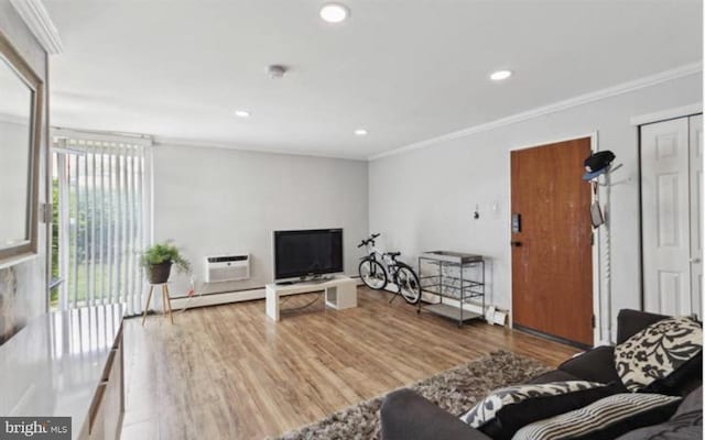 living room featuring a wall mounted air conditioner, hardwood / wood-style flooring, and ornamental molding