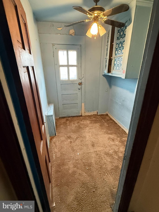 doorway with ceiling fan