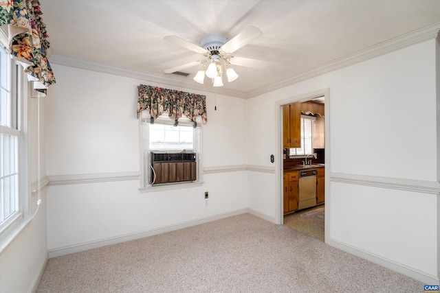 carpeted spare room featuring ceiling fan, crown molding, cooling unit, and sink