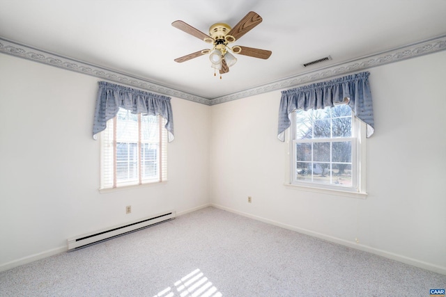 carpeted spare room with ceiling fan and a baseboard heating unit