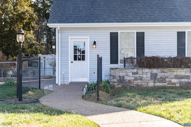 property entrance with a lawn