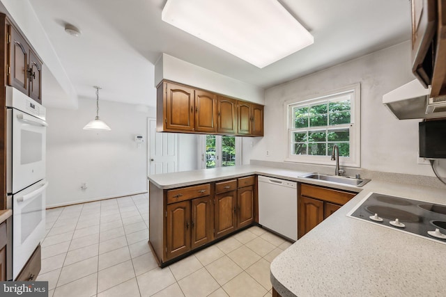 2700 Bellmawr Ct, Silver Spring, MD 20906 - kitchen with a sink, white appliances, light countertops, a peninsula, and decorative light fixtures