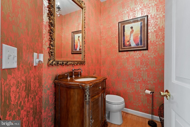 bathroom featuring hardwood / wood-style floors, vanity, and toilet