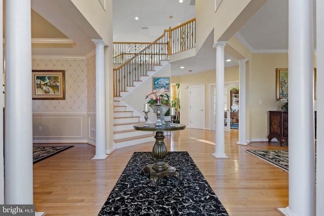 foyer entrance featuring light hardwood / wood-style floors and crown molding