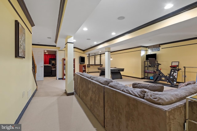 carpeted living room with ornate columns and crown molding