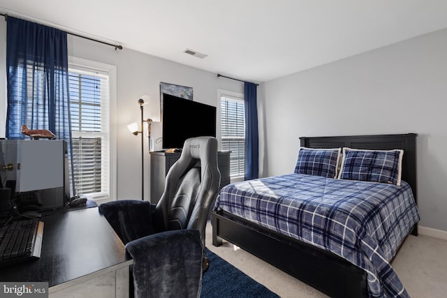 bedroom with carpet flooring and multiple windows