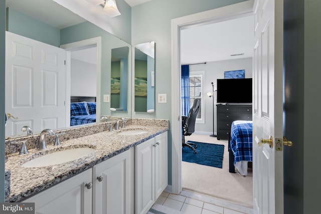 bathroom with tile patterned floors and vanity