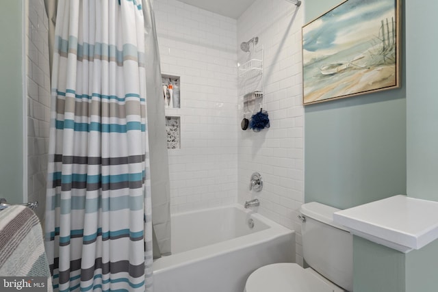 bathroom featuring shower / tub combo and toilet