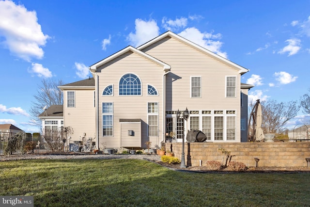 back of house featuring a lawn and central AC