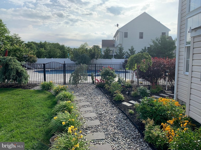 view of yard with a fenced in pool