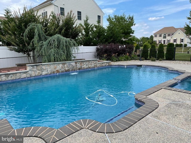 view of swimming pool with pool water feature