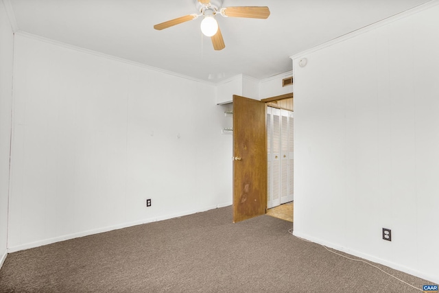 spare room featuring carpet floors, ceiling fan, and crown molding