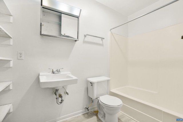 full bathroom with sink, toilet, shower / bathtub combination, and hardwood / wood-style flooring