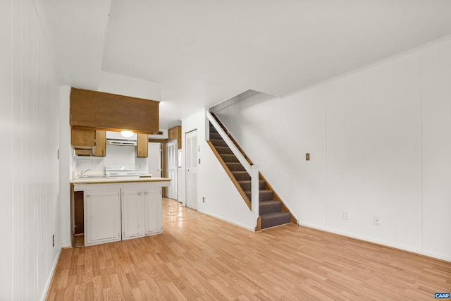 interior space with white range and light wood-type flooring