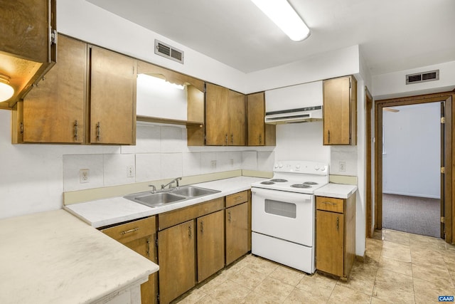 kitchen featuring white range with electric cooktop, backsplash, and sink