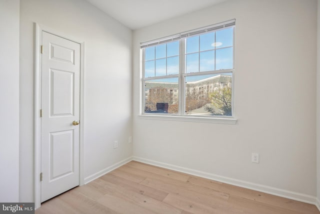 spare room featuring plenty of natural light and light hardwood / wood-style floors