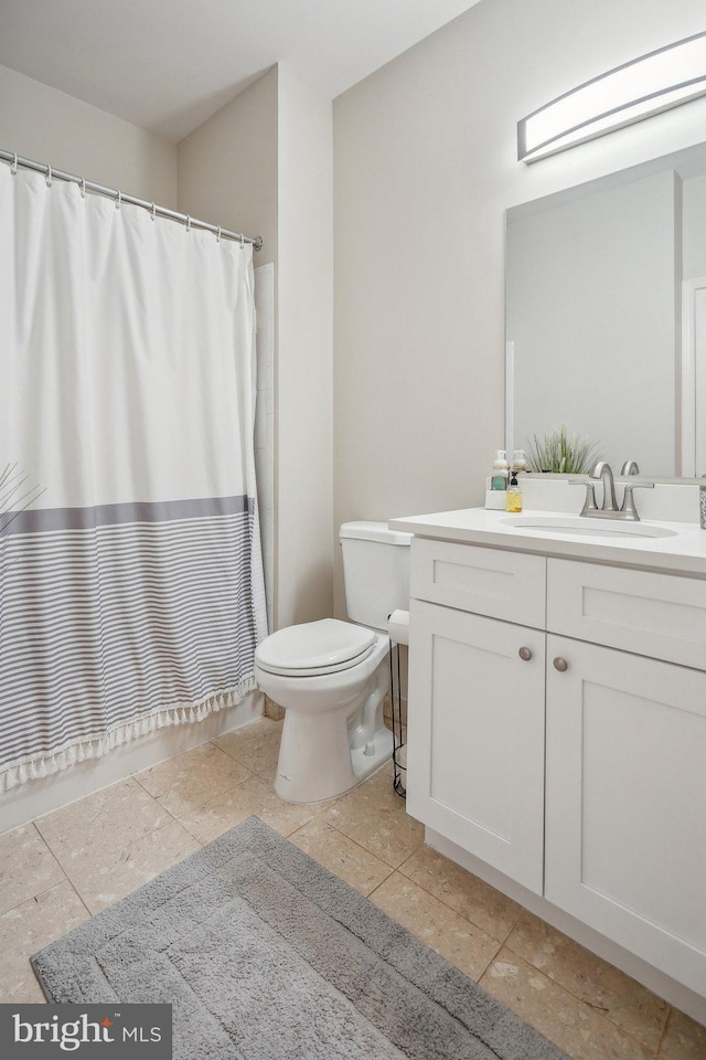 bathroom with tile patterned floors, vanity, and toilet