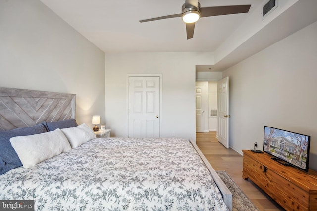 bedroom with ceiling fan and light hardwood / wood-style flooring