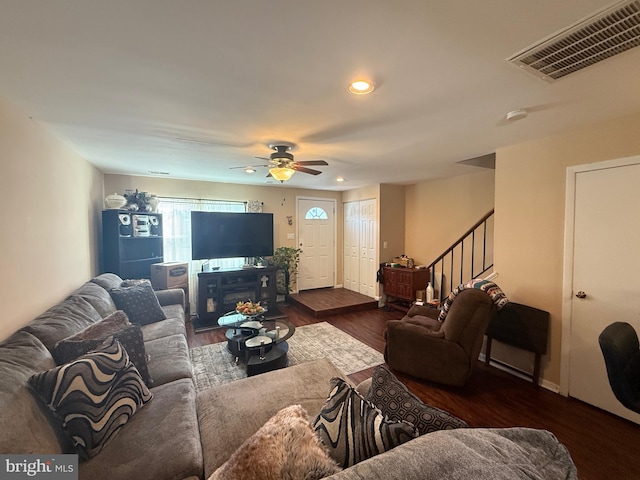 living room with ceiling fan and dark hardwood / wood-style flooring