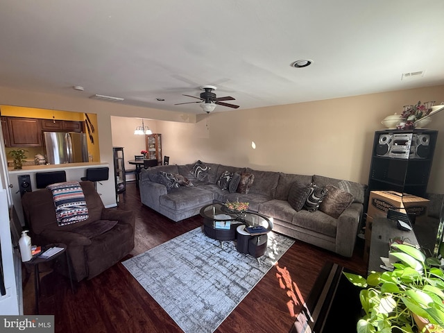 living room with dark hardwood / wood-style floors and ceiling fan