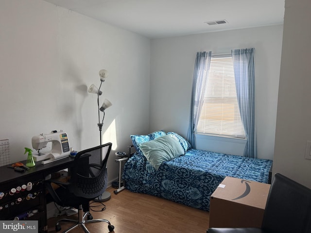 bedroom with hardwood / wood-style flooring