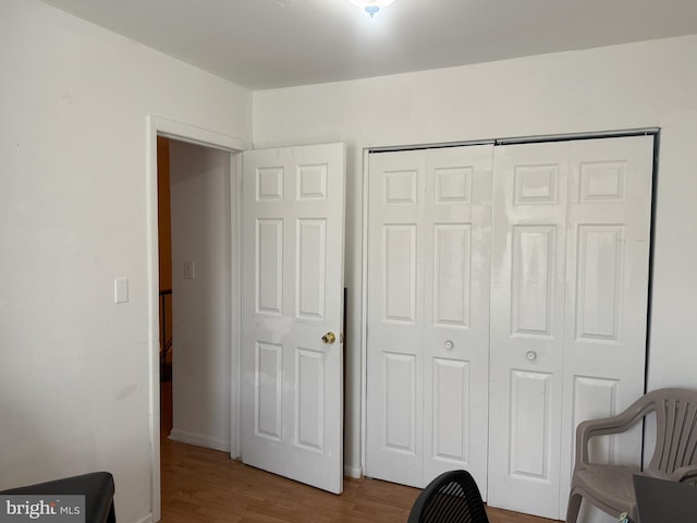 bedroom featuring hardwood / wood-style flooring and a closet