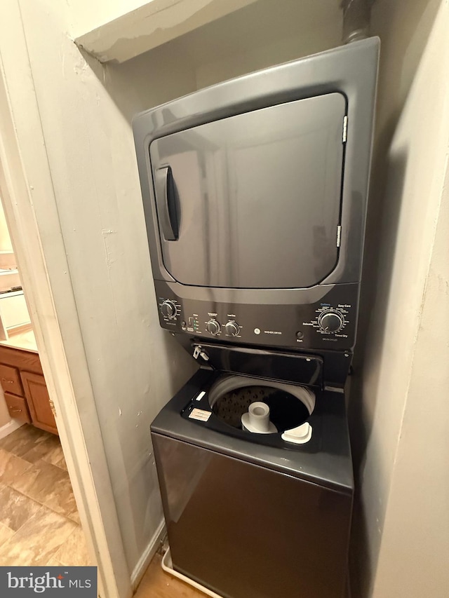 washroom with stacked washer and dryer