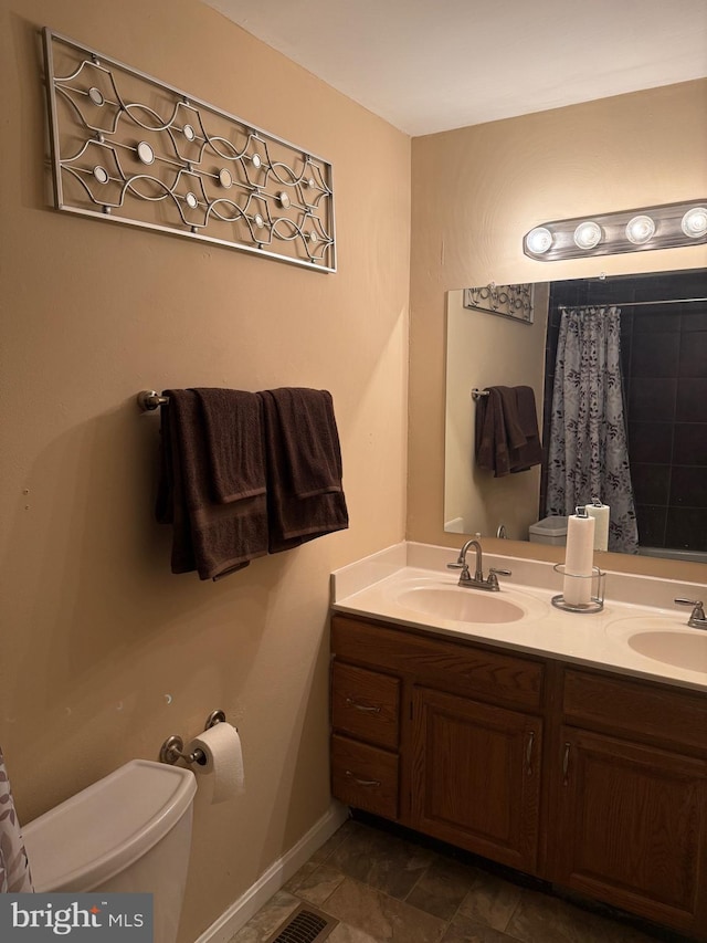 bathroom with vanity and toilet