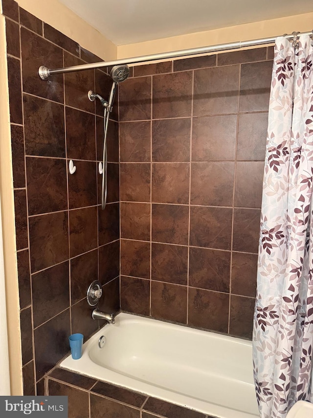 bathroom with shower / bathtub combination with curtain