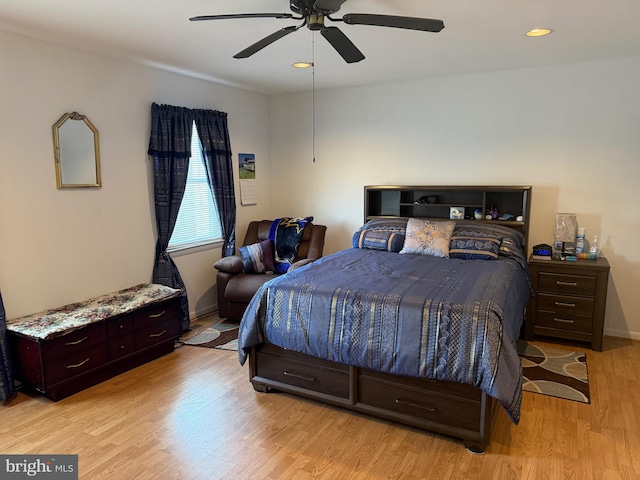 bedroom with ceiling fan and light hardwood / wood-style floors