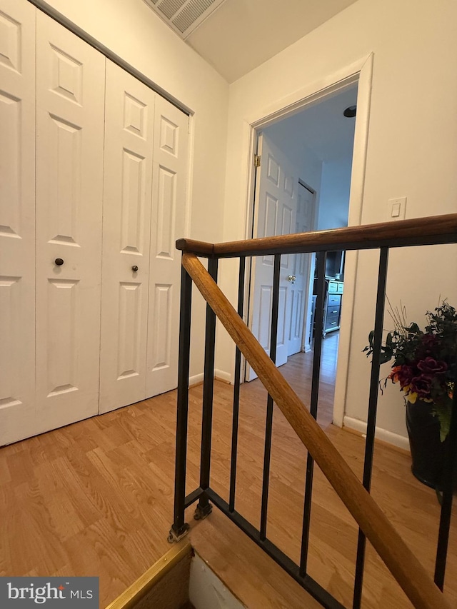 stairs featuring hardwood / wood-style floors