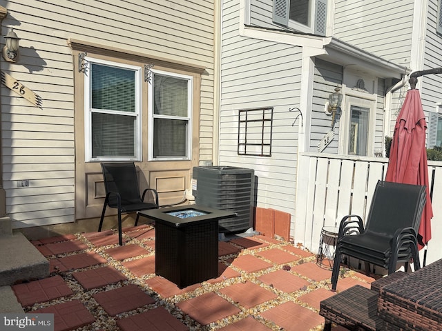 view of patio / terrace with central AC and an outdoor fire pit