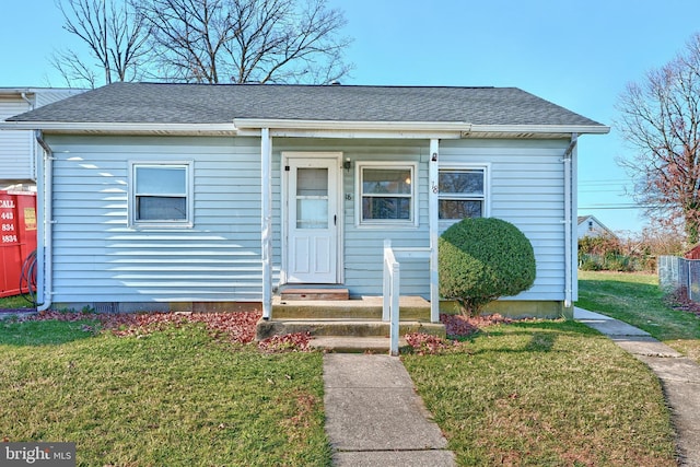 bungalow-style house with a front lawn