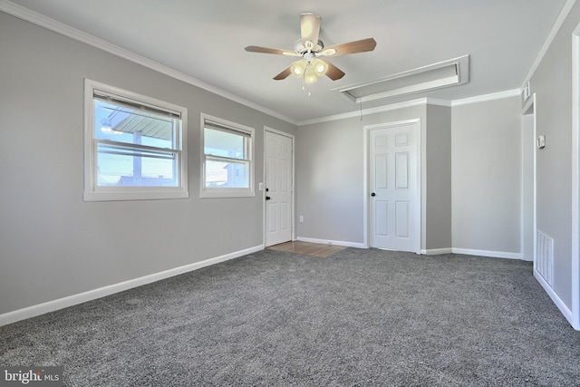 carpeted spare room featuring ceiling fan and crown molding