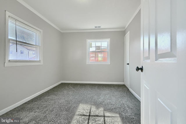 carpeted spare room featuring crown molding