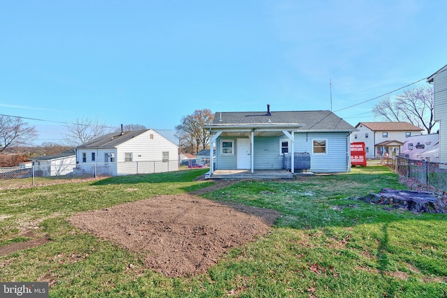 rear view of house with a lawn and a patio