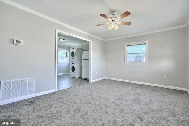 unfurnished bedroom with ceiling fan, stacked washing maching and dryer, carpet floors, white fridge, and ornamental molding