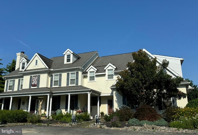 view of front facade with a porch and stucco siding