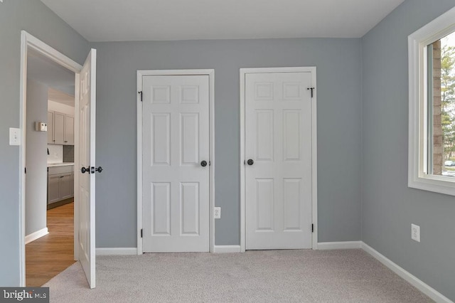 unfurnished bedroom with light colored carpet