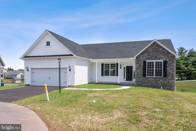 ranch-style home featuring a porch, a garage, and a front lawn