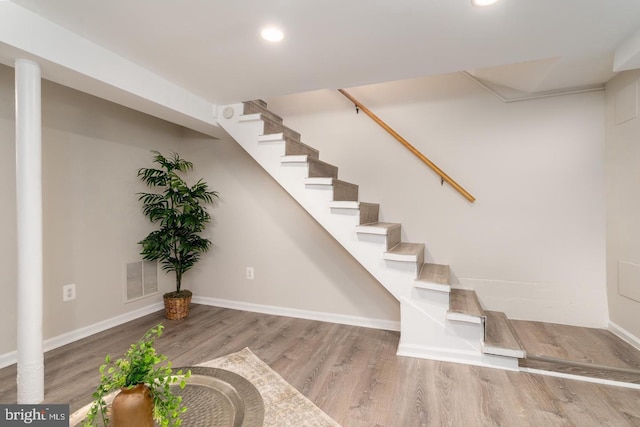 stairs with hardwood / wood-style floors