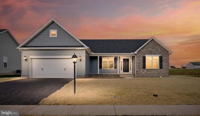 156 Ledger Dr Unit 75, Hanover, PA 17331 - view of front of home with asphalt driveway, a garage, a front lawn, stone siding, and roof with shingles