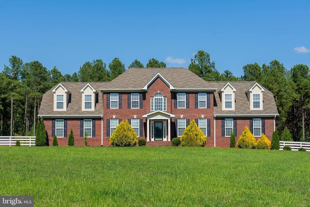 colonial inspired home with a front lawn