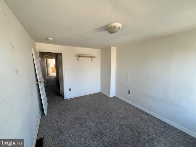 unfurnished bedroom with carpet floors and baseboards