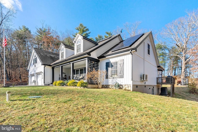 view of property exterior with solar panels, cooling unit, a porch, a garage, and a lawn