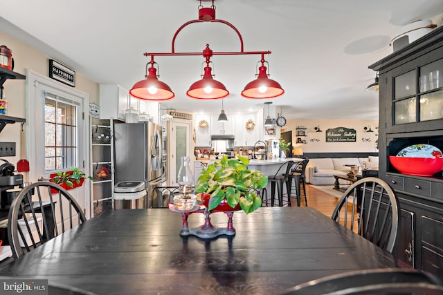 dining area featuring hardwood / wood-style floors and sink