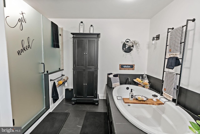 bathroom with tile patterned floors and independent shower and bath