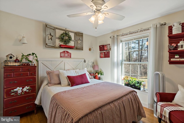 bedroom with wood-type flooring and ceiling fan