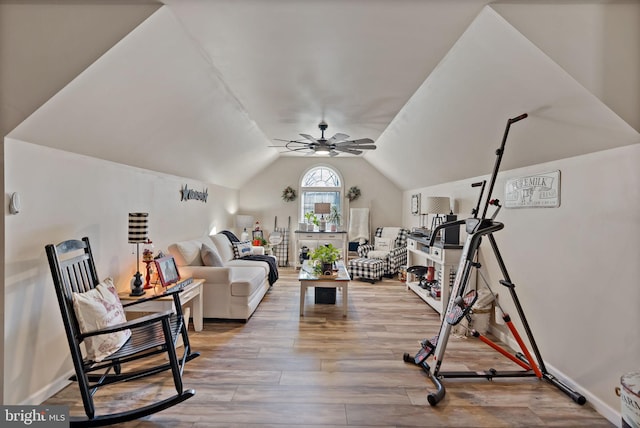 workout room featuring ceiling fan, vaulted ceiling, and hardwood / wood-style flooring