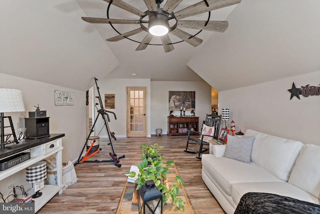 living room with ceiling fan, light hardwood / wood-style flooring, and lofted ceiling